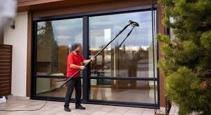 Window cleaner polishing large glass panels
